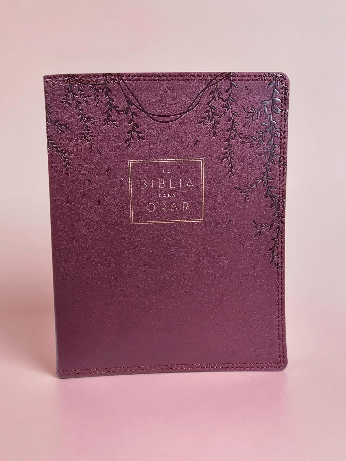 Biblia para Orar de Libreria Wow con cubierta de piel sintética color borgoña y detalles botánicos grabados en relieve